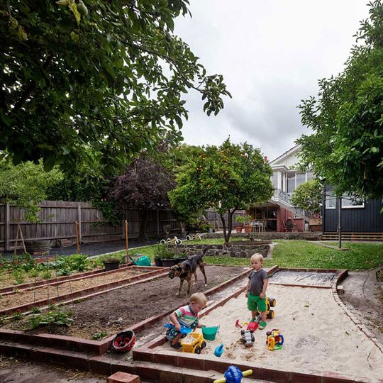 Amy's House garden beds are raised using recycled bricks to create vegetable gardens and a sandpit