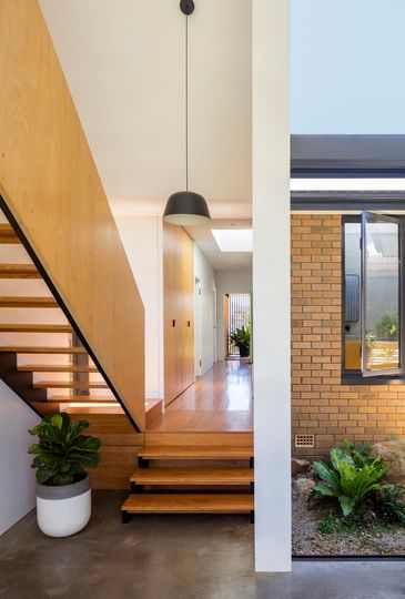 Contrasting Addition Complements a Sixties Yellow Brick Home