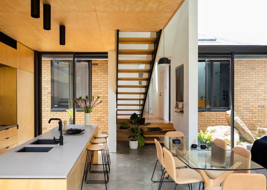 Contrasting Addition Complements a Sixties Yellow Brick Home