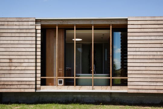 This Home Is Grounded Into Its Site by Walls of Gabion Baskets