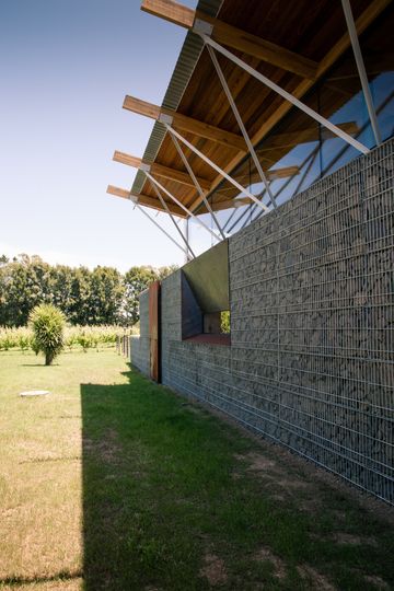 This Home Is Grounded Into Its Site by Walls of Gabion Baskets