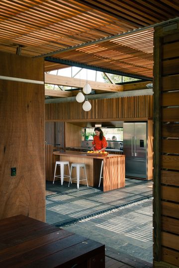 This Home Is Grounded Into Its Site by Walls of Gabion Baskets