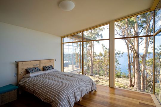 Bruny Shore House bedroom has a large window overlooking the ocean