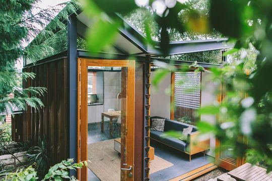 Copper House Takt Studio for Architecture bifold doors open the living space onto the lush garden