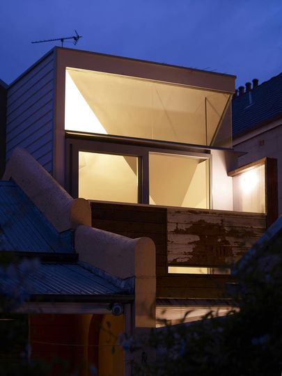 At night Fitzroy Terrace in Sydney's new rear extension glows against a patina of finishes