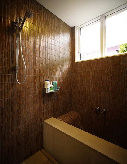 Haberfield House bathroom with mosaic tiles and sculpted build in bath