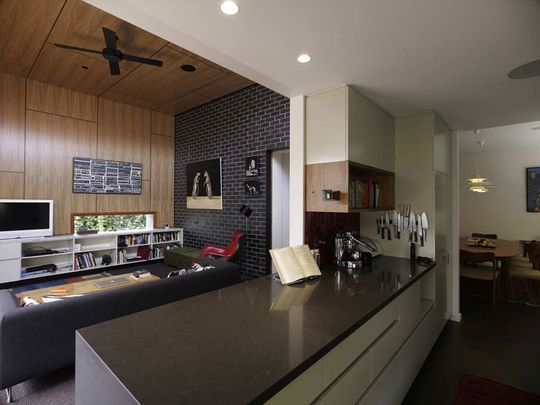 Haberfield House view of living area from kitchen showing timber wall and ceiling