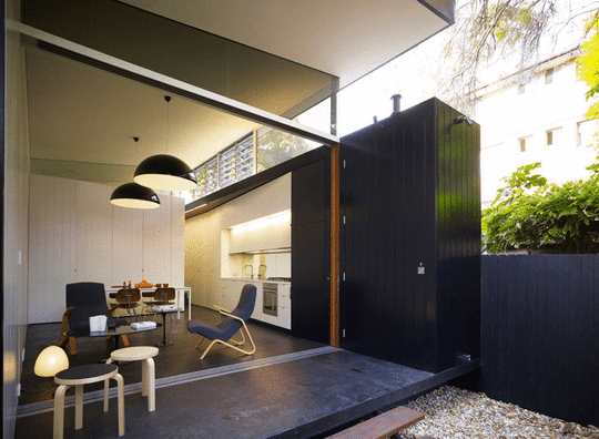 Haines House has a late sliding door that disappears into a pocket in the work spine to completely open the living area to the garden