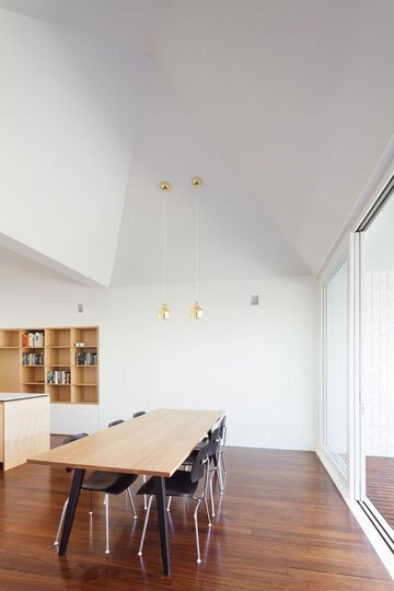 Timber floorboards and sculpted ceiling are the show stoppers in House Chapple's dining area