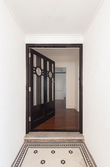 The original 1920s front of House Chapple has been maintained, including this gorgeous door and entry tiling