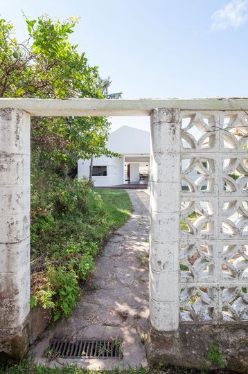 From the rear entry of House Chapple, the original concrete breeze block wall remains -- a reminder from the era when this family first moved in