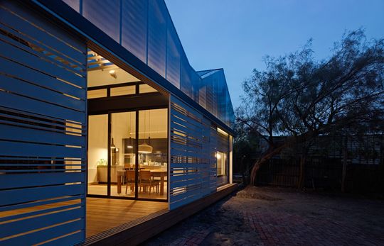 The new facade at the rear of the House Reduction glows at night