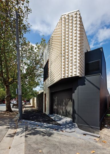 The rear garage and studio is built from brick and has a textural brick pattern in House Reduction