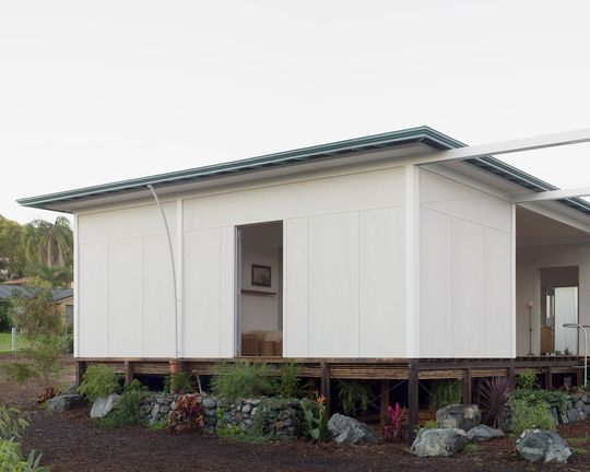 A House with a Guest Room is Created with Three Simple Pavilions