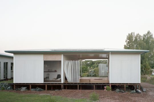 A House with a Guest Room is Created with Three Simple Pavilions