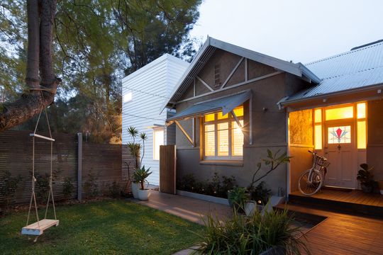 A White Box is 'Plugged' Into the Side of This Existing Home