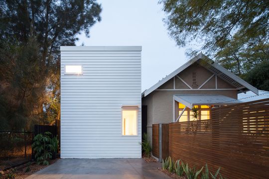 A White Box is 'Plugged' Into the Side of This Existing Home