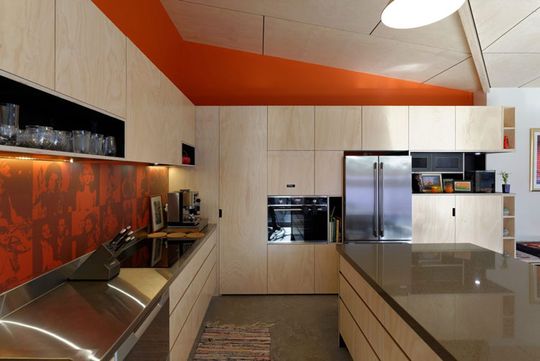 Splashes of orange enliven Islington House kitchen