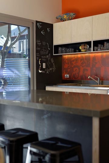 Islington House kitchen splash of orange, blackboard and benchtop