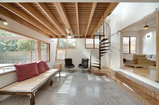 A Cozy, Nest-Like Mezzanine Studio Floats Above This Living Space