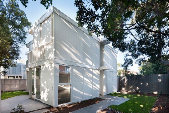 Folded Facades Give Two Identical Homes Their Own Identity