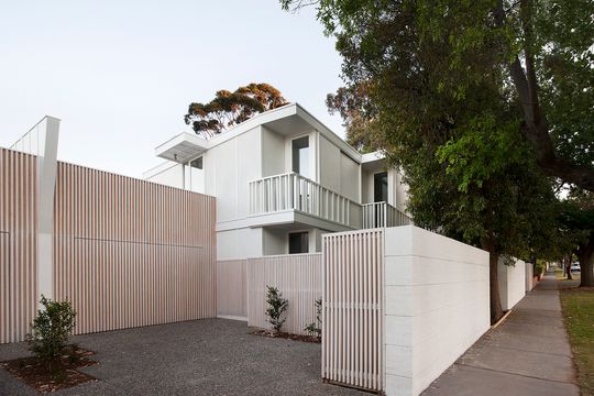 Folded Facades Give Two Identical Homes Their Own Identity