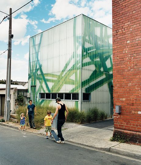 Michael Bellemo, his children and a friend play outside their modern spray painted home, Polygreen