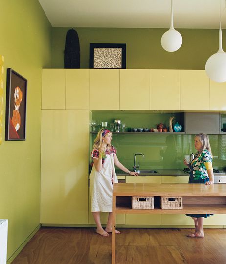 Cat Macleod and daughter Celeste enjoy drink and a chat in their modern kitchen in their home Polygreen