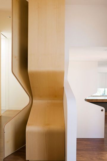 Treehouse cutout detail is even incorporated into a joinery unit which bends to follow the curving form